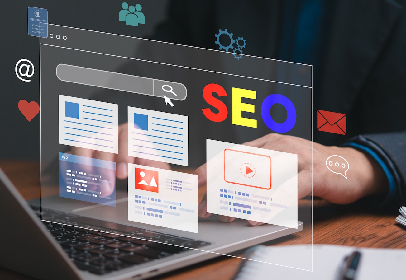 Person typing on a laptop computer with the letters SEO and graphs showing above it